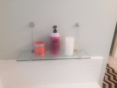 Cute glass shelf for tub necessities.